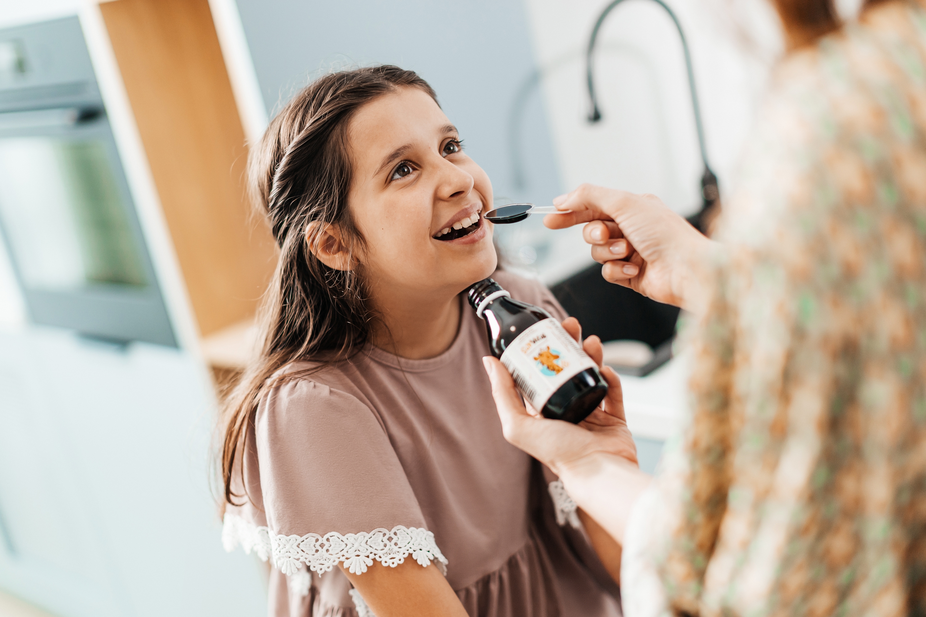girl and woman giving her SunVital syrup